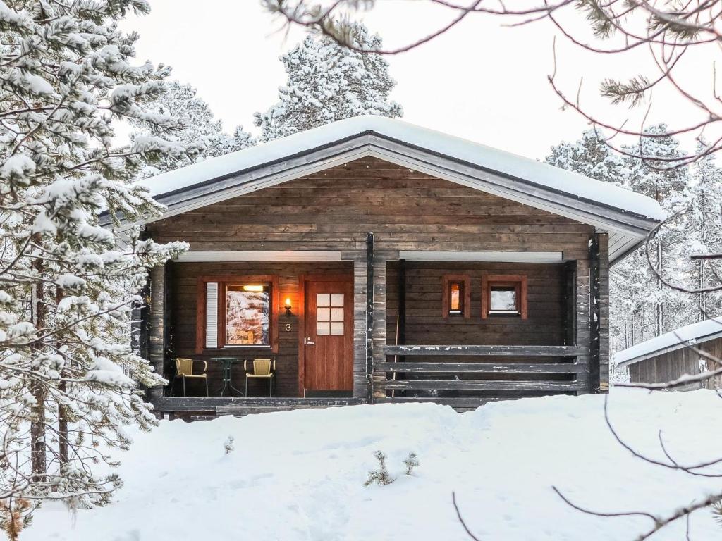 a log cabin in the snow in the woods at Holiday Home Lemmenliekki 3 by Interhome in Lemmenjoki