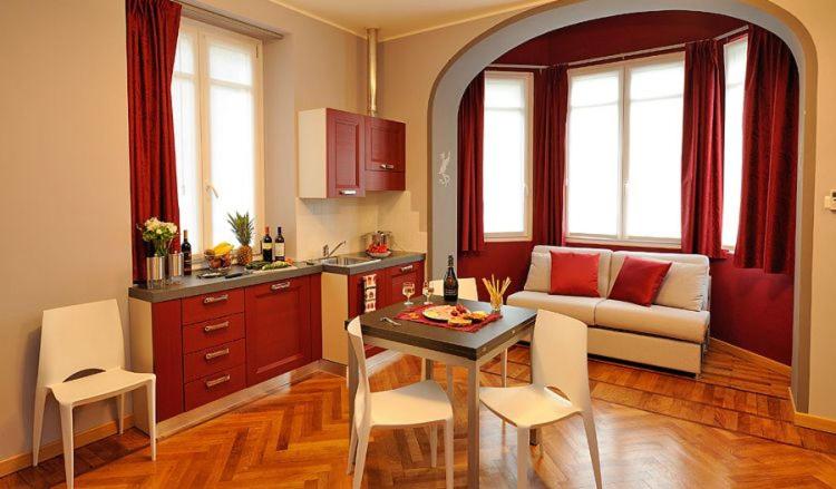 a kitchen and living room with a table and a couch at Residence Villa Maurice in Stresa