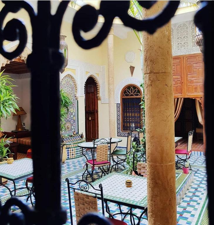 a courtyard with tables and chairs in a building at Riad Dar Zouhour in Rabat