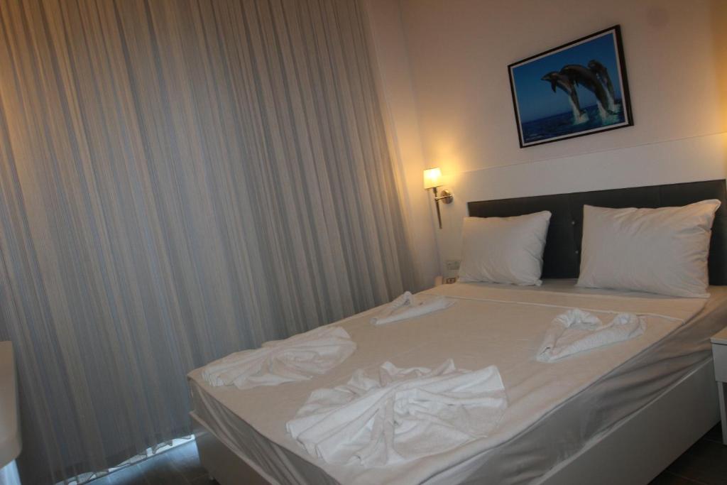 A bed or beds in a room at LİMAN BOUTIQUE OTEL