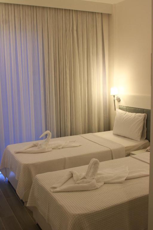 A bed or beds in a room at LİMAN BOUTIQUE OTEL