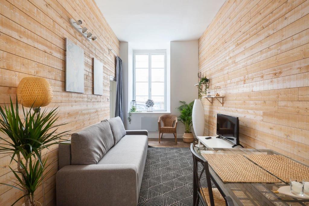 a living room with a couch and a fireplace at Cosmic by Cocoonr in Rennes