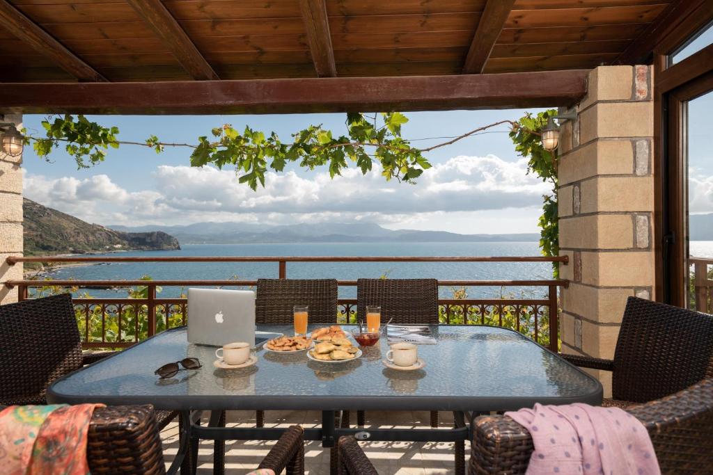 - une table sur un balcon avec un ordinateur portable dans l'établissement Sunset Traditional House, à Ravdhoúkha