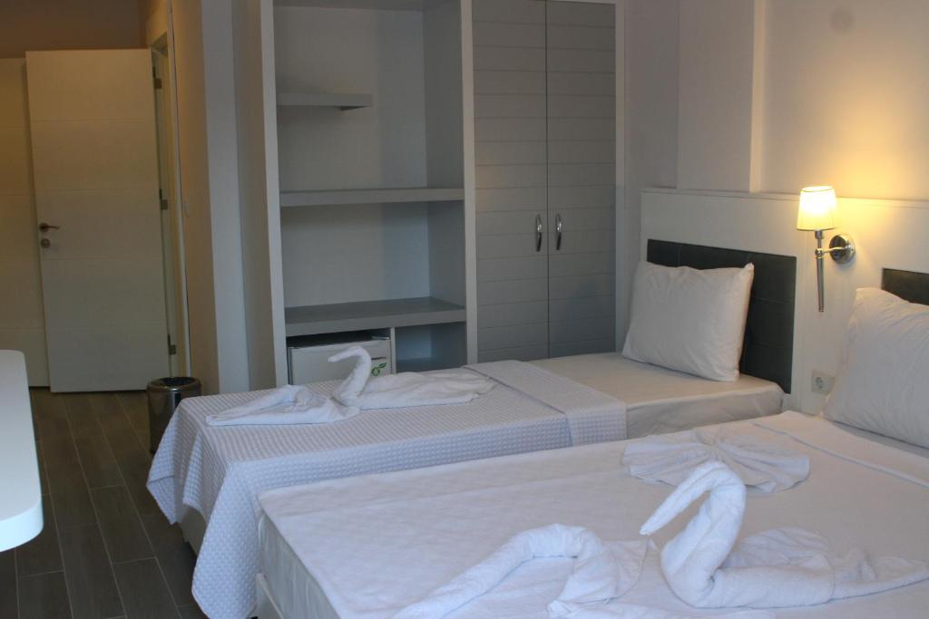 A bed or beds in a room at LİMAN BOUTIQUE OTEL