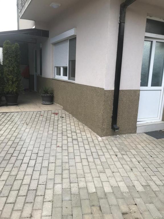a house with a brick driveway in front of a building at Apartment Delfina in Ohrid