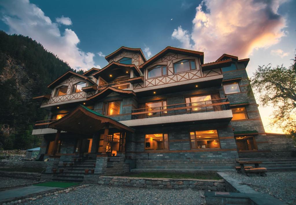 a large wooden house with lights on at Hotel Batseri SANGLA in Sāngla