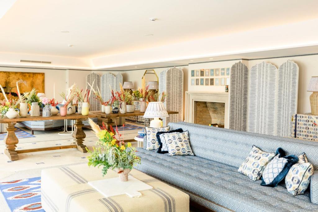 a living room with a blue couch at The Albatroz Hotel in Cascais