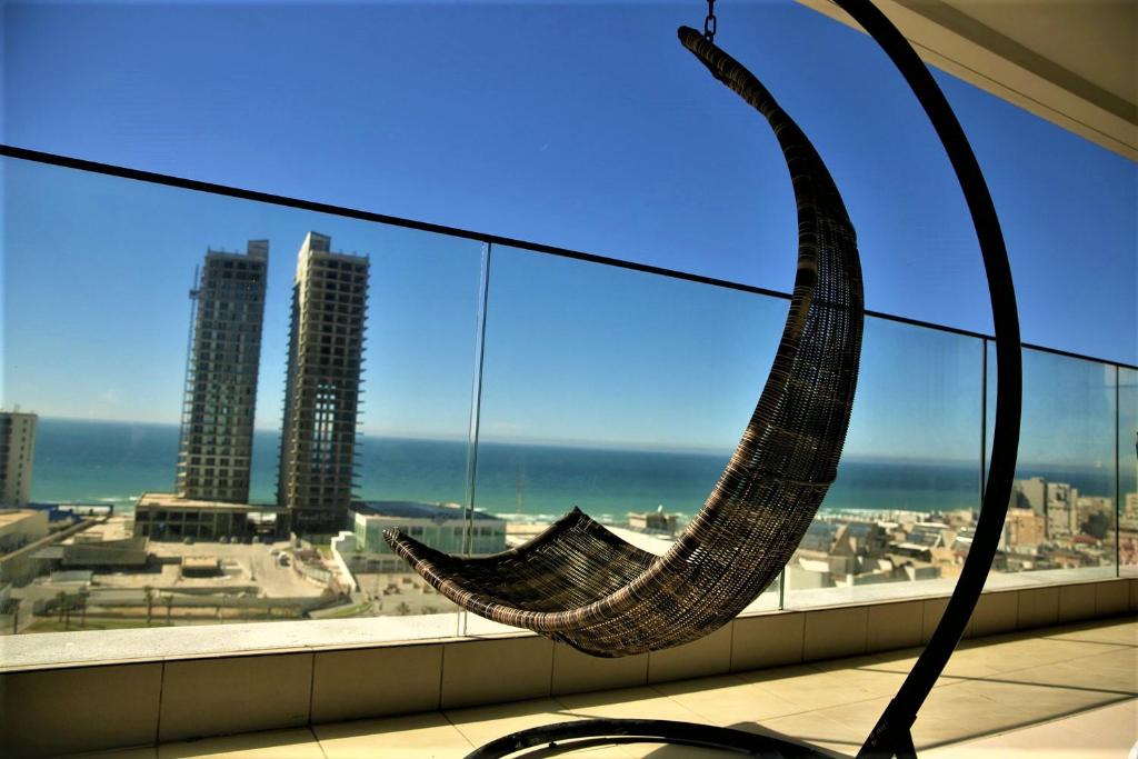a hammock hanging from a window in a building at Bat Yam Luxery 5BR Sea View Suite in Bat Yam