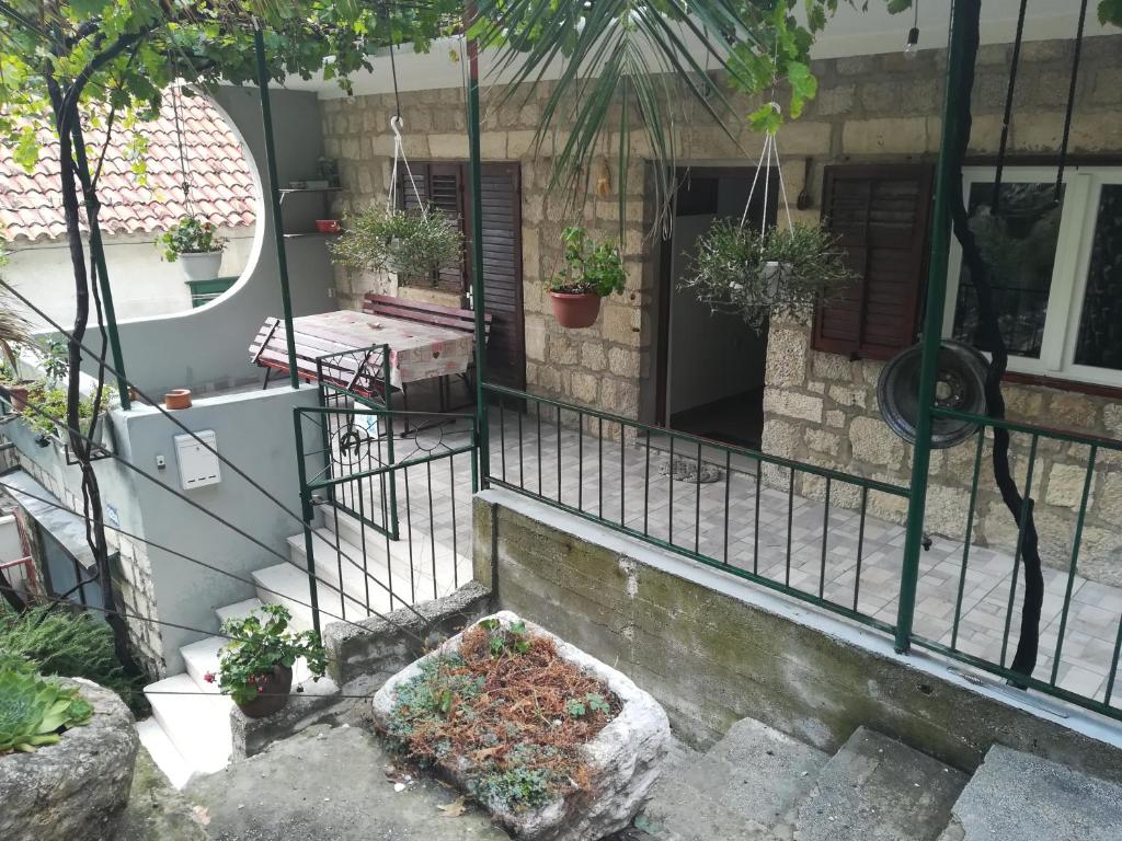 a balcony of a house with potted plants on it at Apartmani Maruncic in Omiš