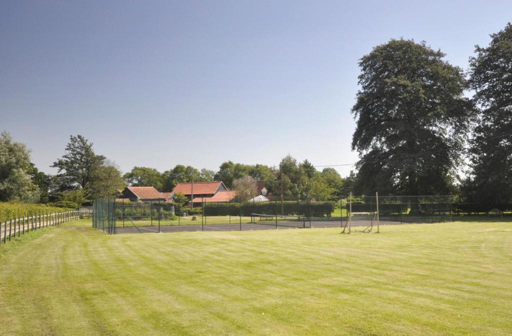 a field with a soccer field with a goal at Partridge Lodge Self Catering houses in Woodbridge
