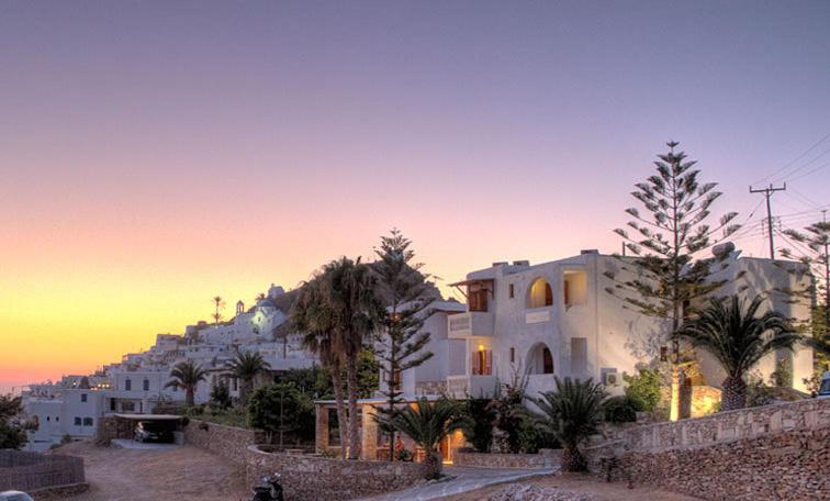 a group of white buildings with a mountain in the background at Village Twins in Ios Chora