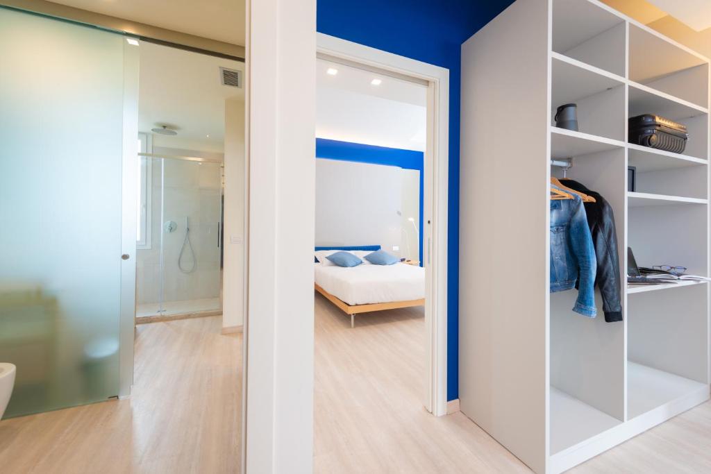 a room with a bed and a glass door leading to a bedroom at Amarina Hotel in Marina di Pietrasanta