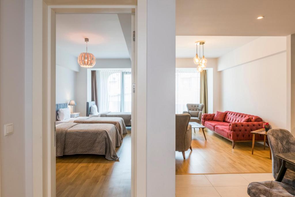 a bedroom with a bed and a living room at Classy Suite Taksim in Istanbul