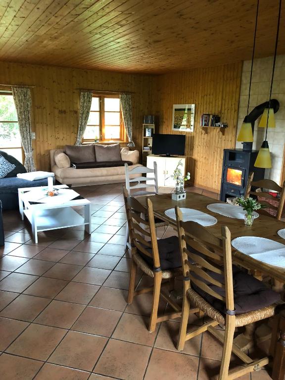a living room with a table and chairs and a couch at Hof Keske in Peissen