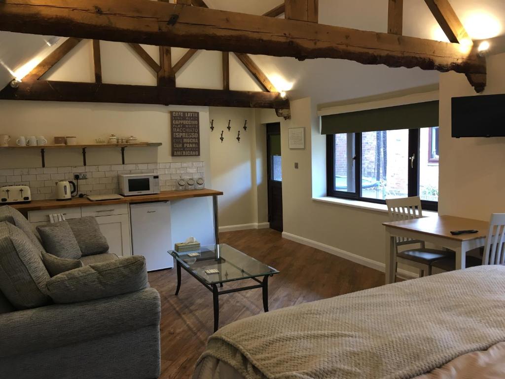 a living room with a couch and a table at The Stables At Harby in Melton Mowbray