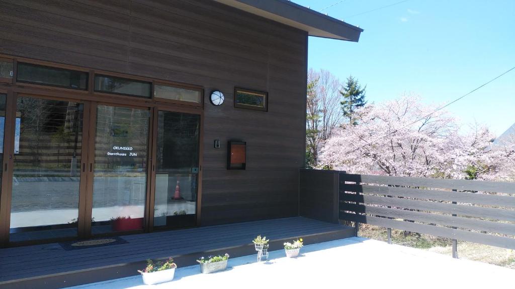 a building with a clock on the side of it at Okunikko Guesthouse JUN in Nikko