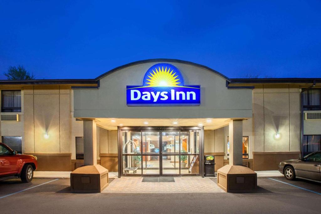 un cartello giornaliero di fronte a un edificio di Days Inn by Wyndham Iselin / Woodbridge a Iselin