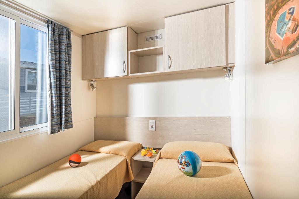 a hospital room with two beds and a window at Villaggio San Francesco in Duna Verde