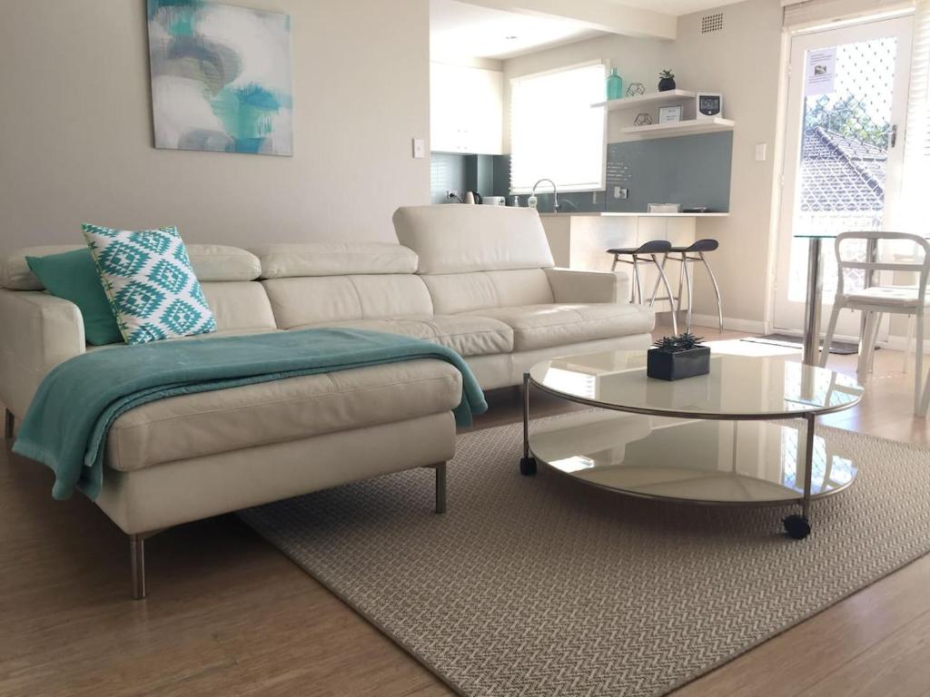 a living room with a couch and a coffee table at Cronulla Beach Break in Cronulla