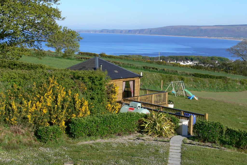 a house on a hill with a view of the water at Rustic Log Cabin in Greencastle