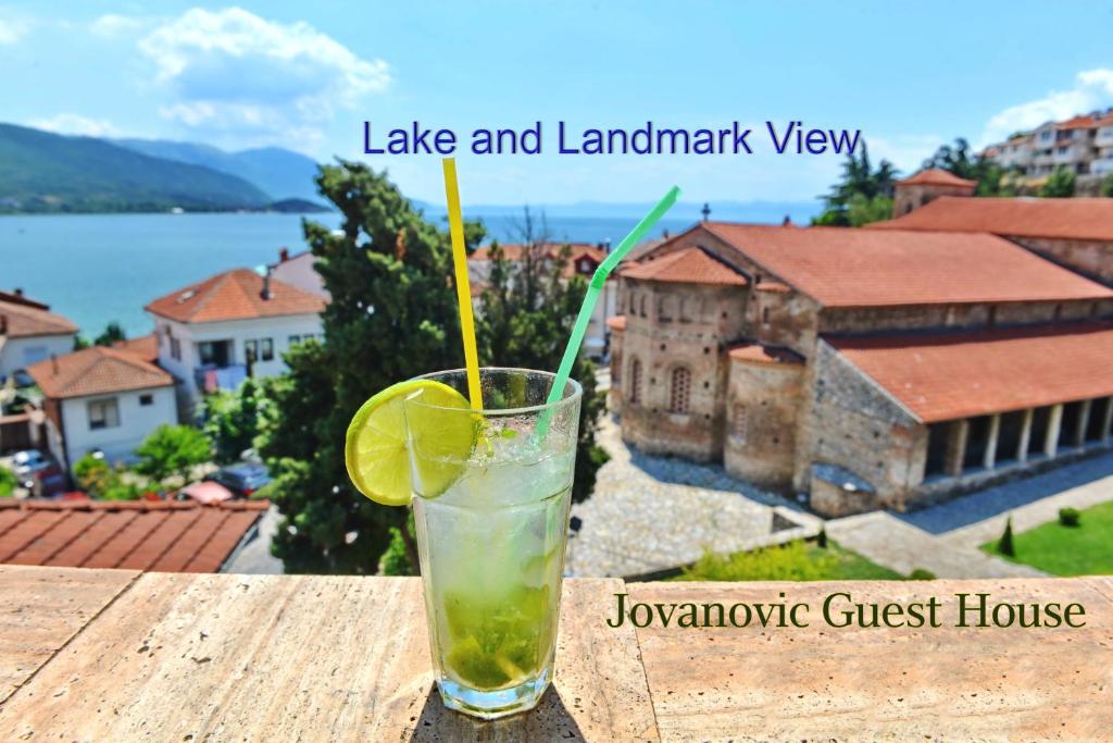 a drink sitting on top of a table with a view at Jovanovic Guest House in Ohrid