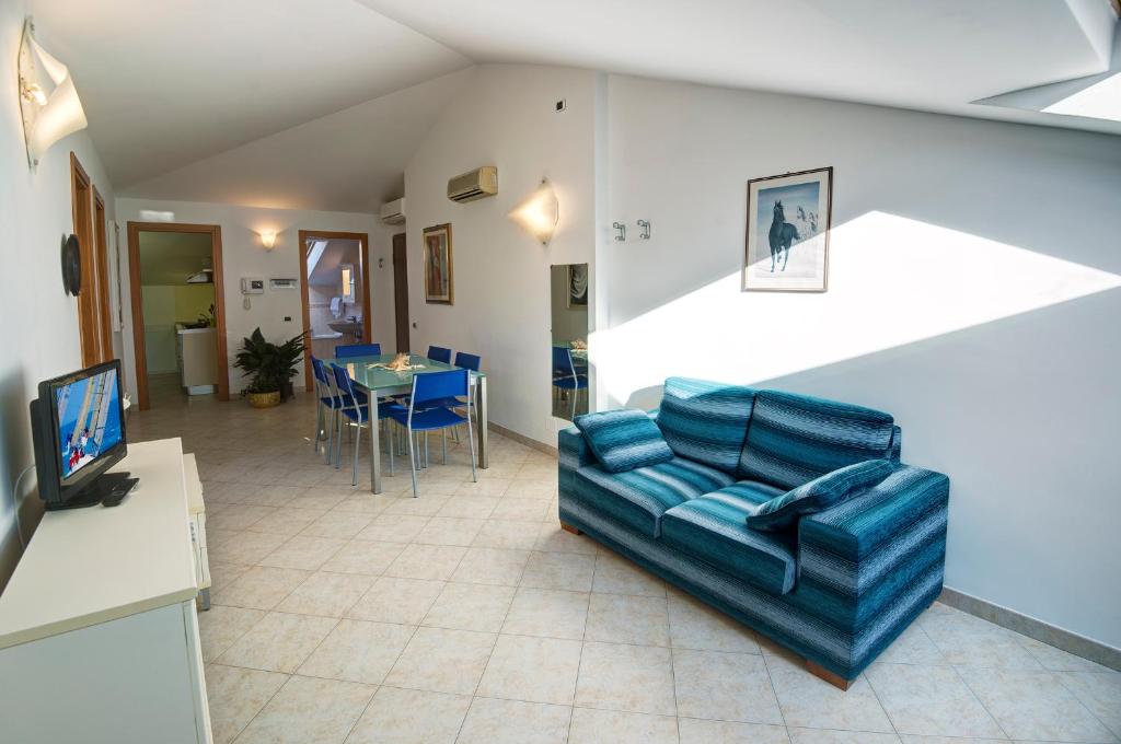 a living room with a couch and a table at Appartamenti Palmaria in Diano Marina