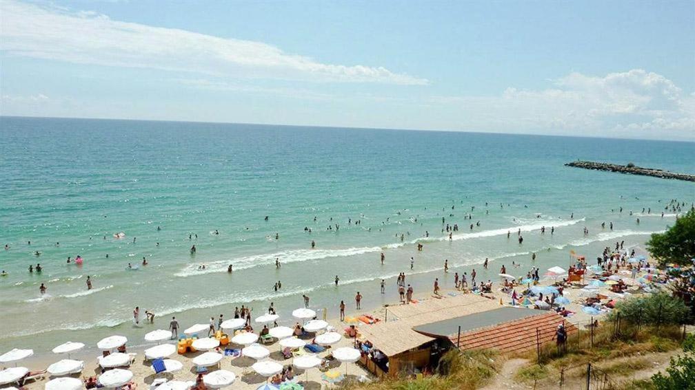 a crowd of people on a beach with umbrellas at Blue Marine Ap 26 in Ravda