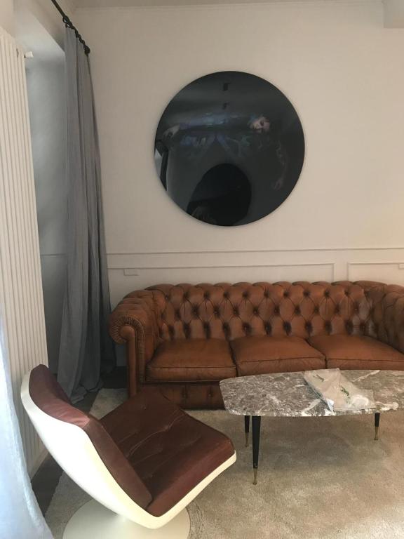 a living room with a brown couch and a table at Suites Menaggio in Menaggio