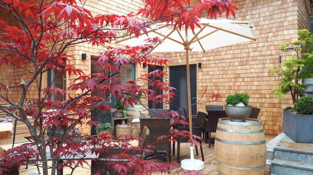 a tree with red leaves in front of a building at Hotel Kimmig in Bad Peterstal-Griesbach