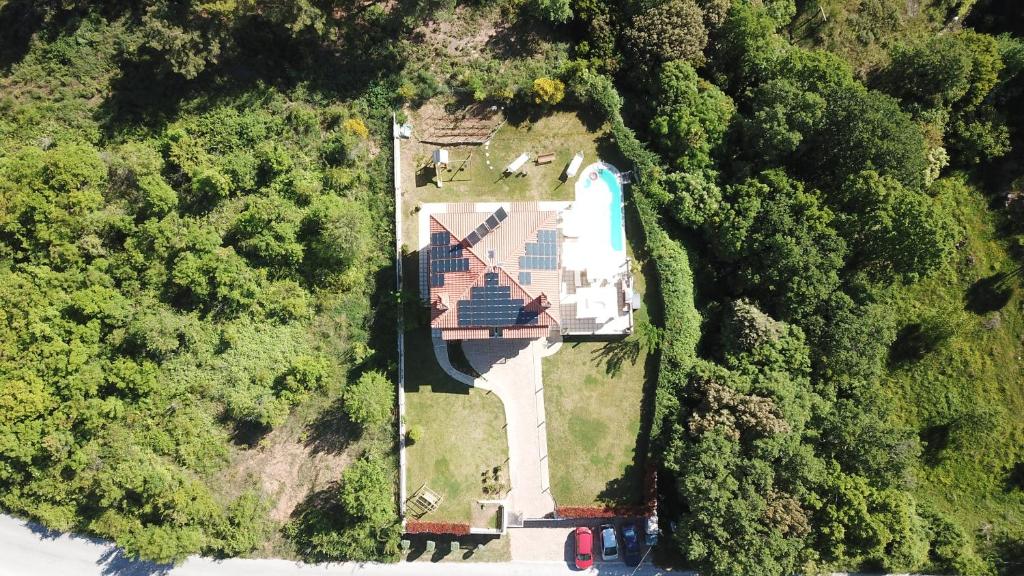 an aerial view of a house in the forest at Evmorfes Villas in Poligiros
