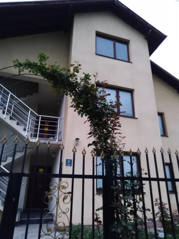 a white house with a black fence at Holiday Home Iman in Sarajevo