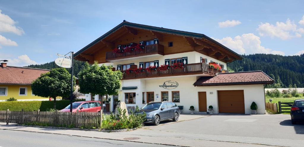 a building with cars parked in front of it at Ferienhaus Alpenland in Flachau