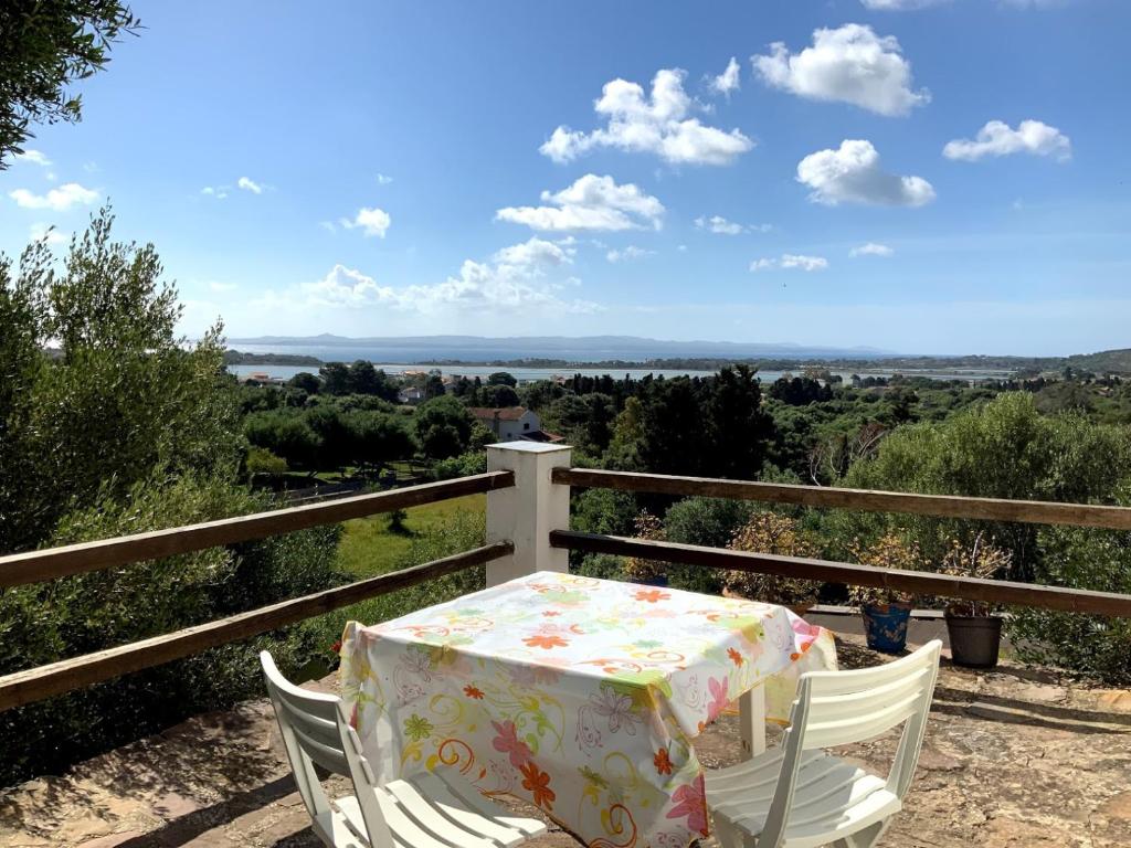 a table and chairs on a balcony with a view at Cá da Marta Q4526 in Carloforte