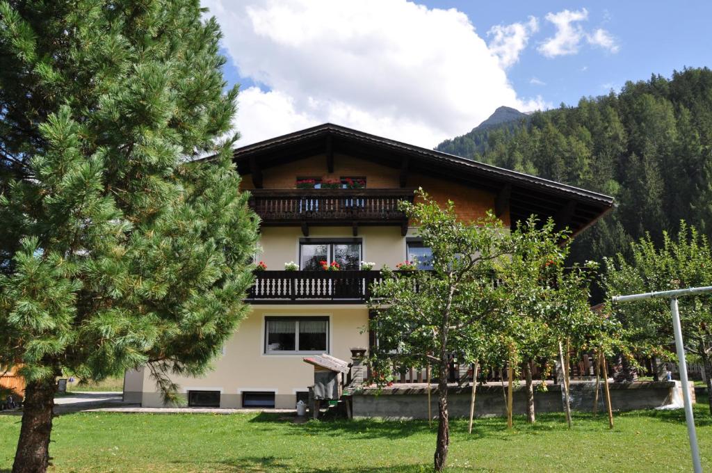 a house with a balcony and trees in front of it at Haus Freispitzblick in Bach