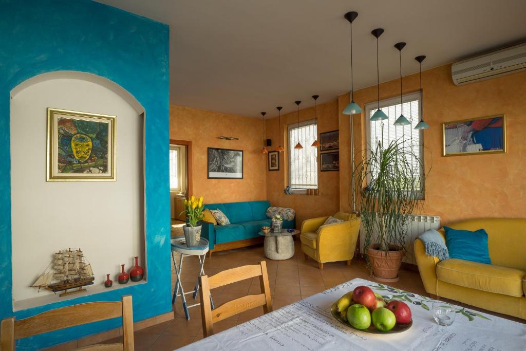 a living room with a table with fruit on it at ASTAKOS apartments Budva in Budva