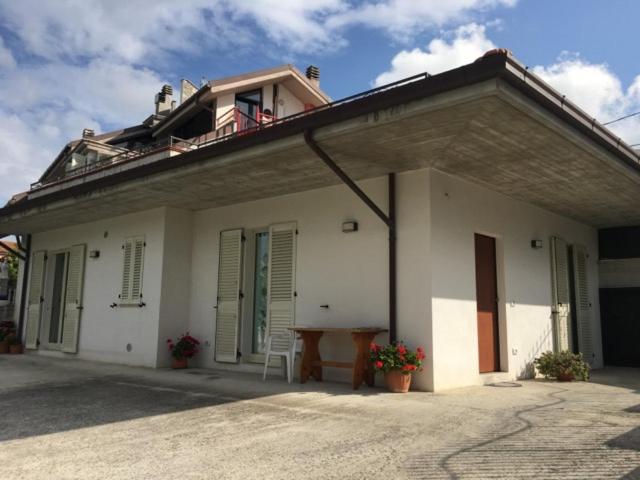 a white house with a table in front of it at Spineola in Spinetoli