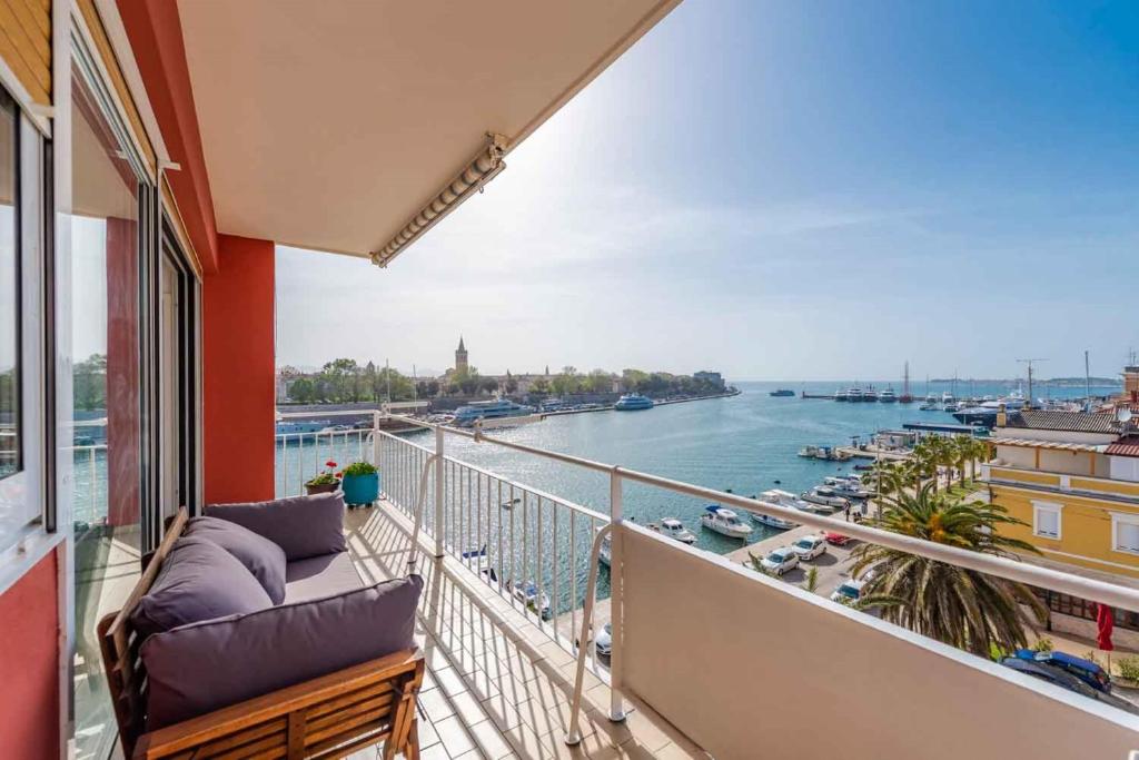 a balcony with a view of a river at Sea the Sunset Apartment in Zadar