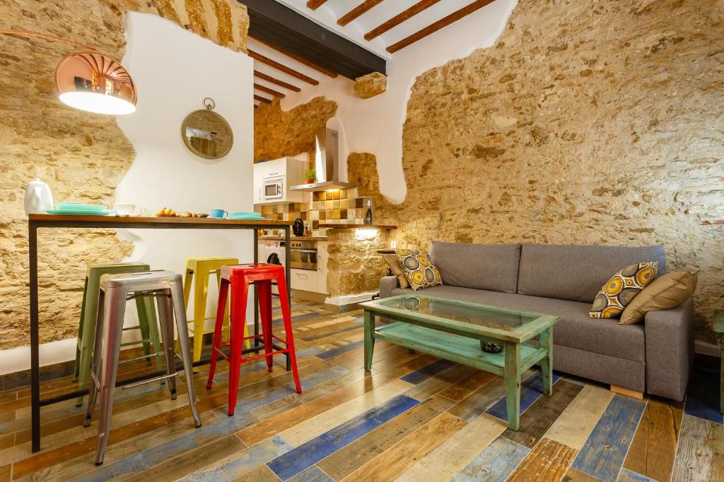 - un salon avec un canapé et des tabourets colorés dans l'établissement Noah House city center - Historic center, à Cadix