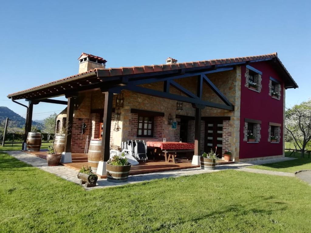 a large house with a roof with a patio at La Milonga in Piloña