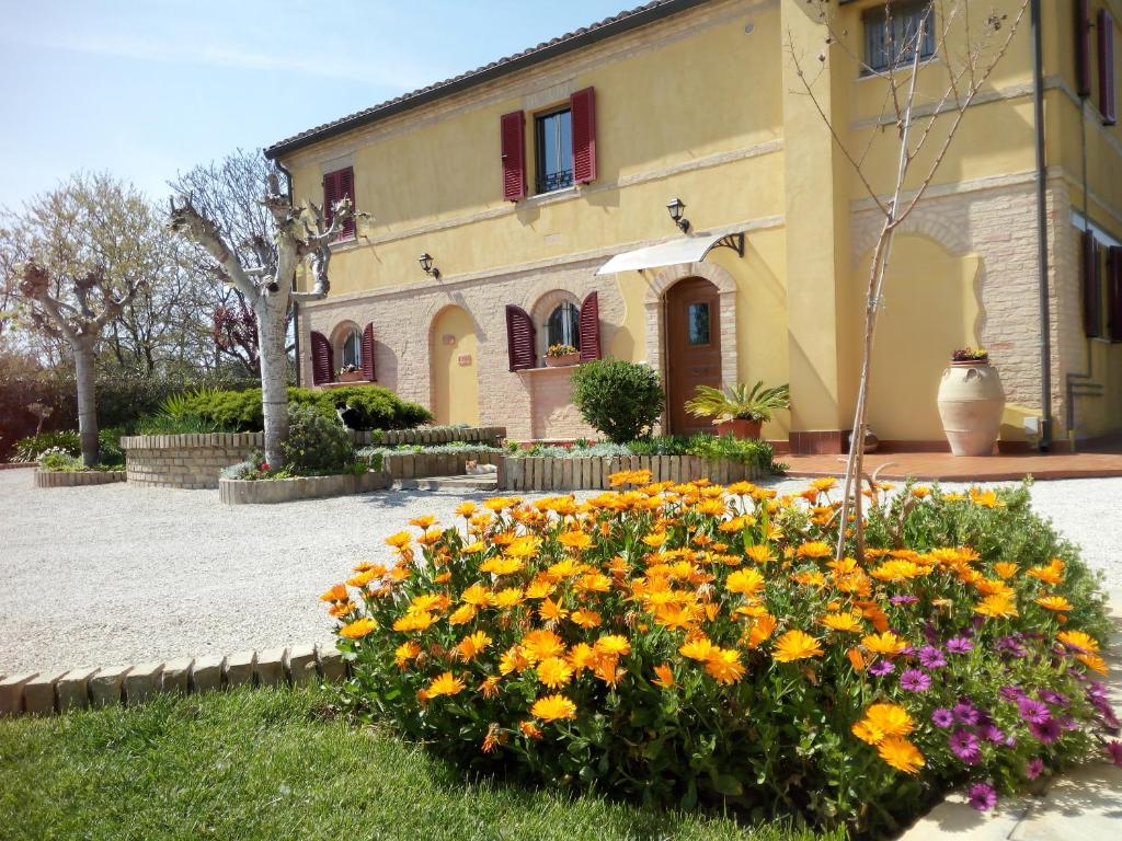 a house with a bunch of flowers in front of it at A Casa Di Pici in Porto Potenza Picena