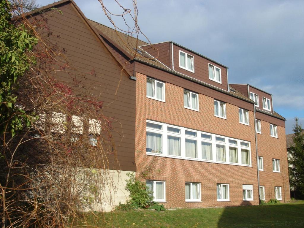 ein Backsteingebäude mit weißen Fenstern an der Seite in der Unterkunft Osterberg - Restaurant und Hotel in Hildesheim