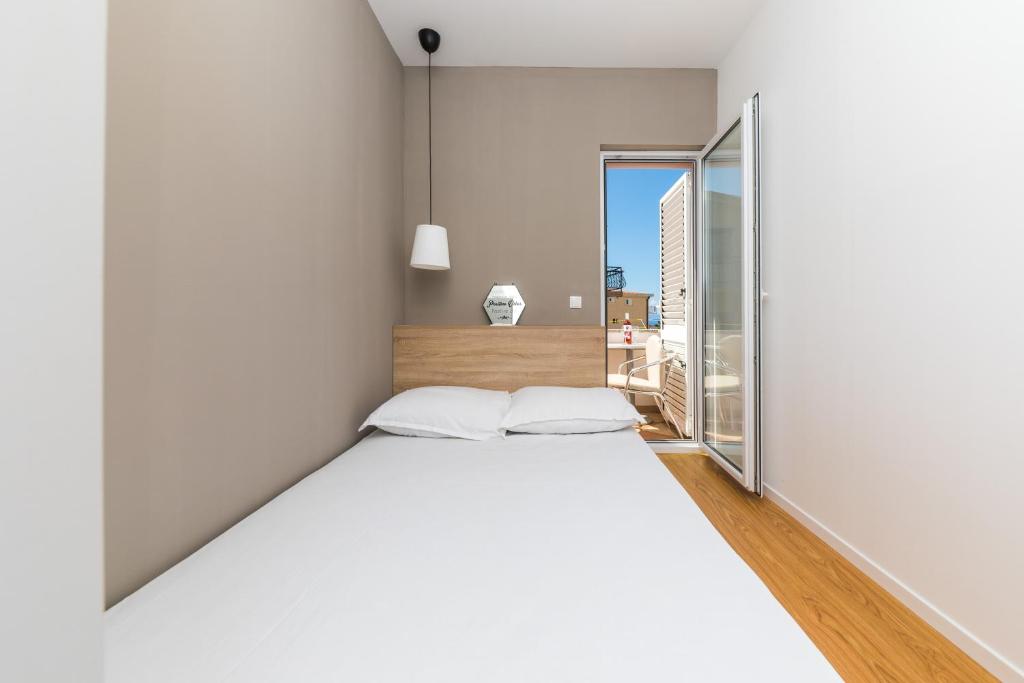 Postel nebo postele na pokoji v ubytování Apartments Gavran