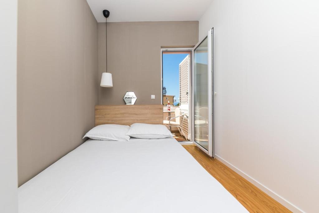 Postel nebo postele na pokoji v ubytování Apartments Gavran