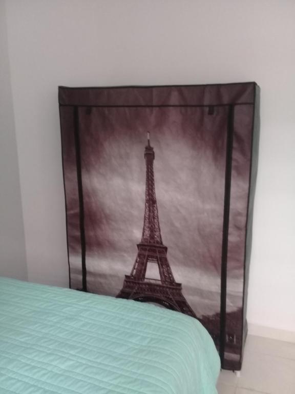 a bedroom with a picture of the eiffel tower at Casa Blanca in Playa del Carmen