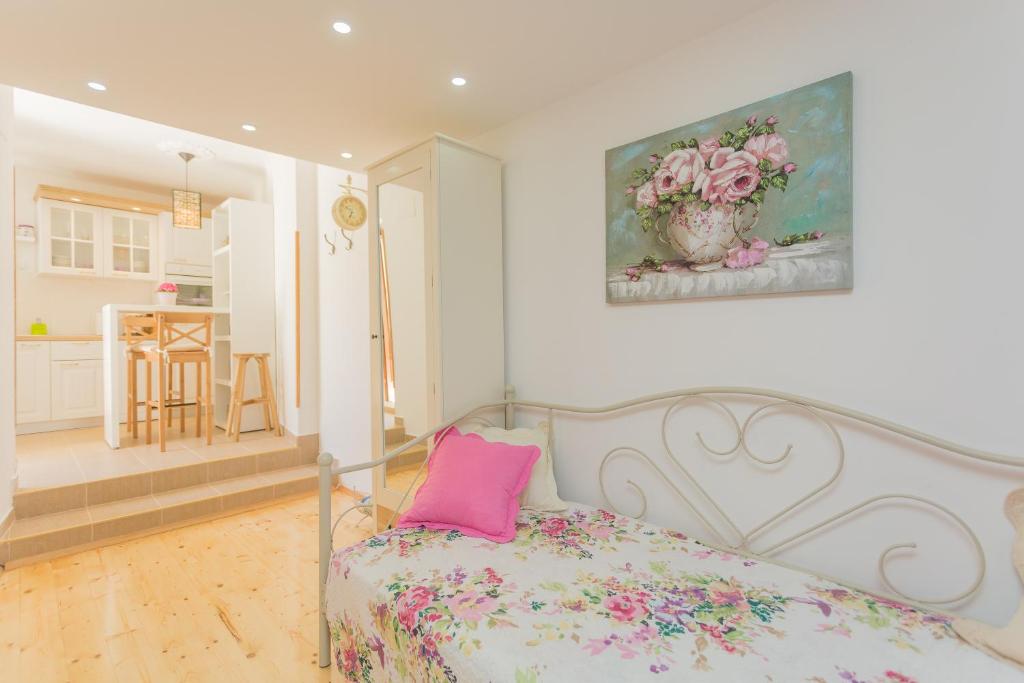 a bedroom with a bed with a pink pillow on it at House - Apartment Dama in Split