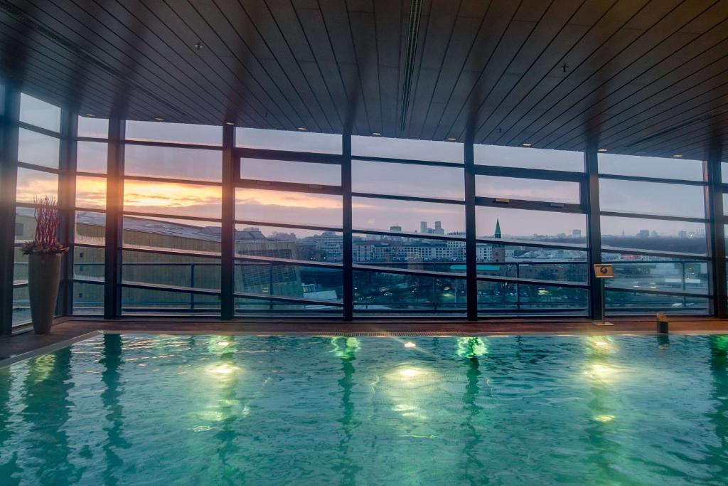 a swimming pool in a building with a view of the city at Grand Hyatt Berlin in Berlin