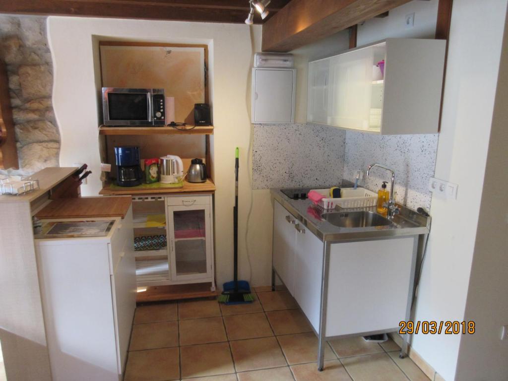 Kuchyň nebo kuchyňský kout v ubytování La Muria Apartment