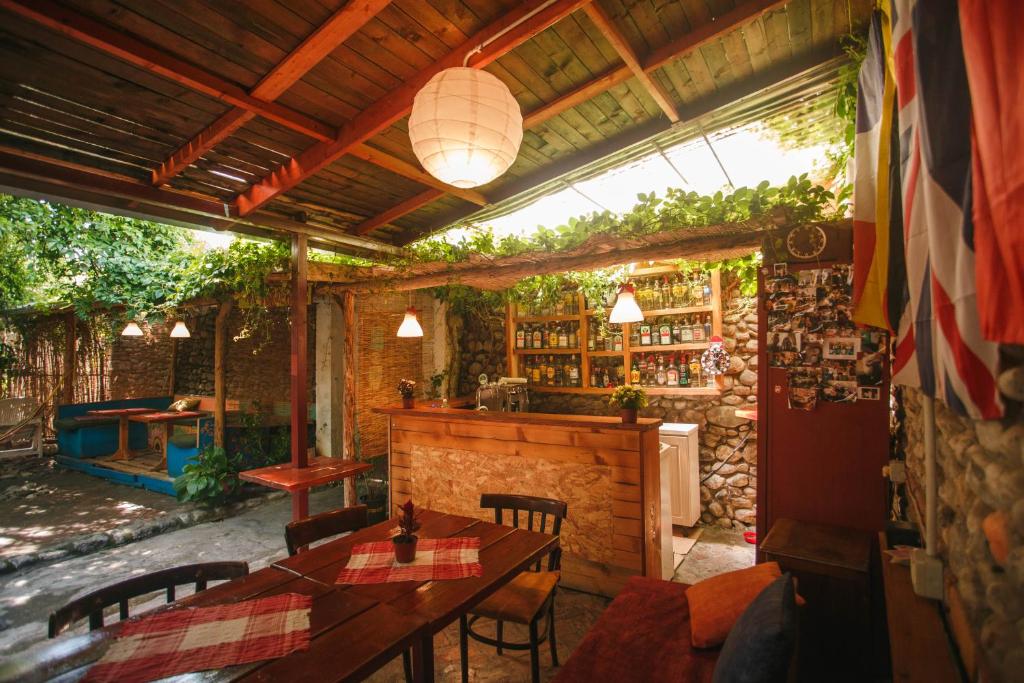 a patio with a table and chairs and a bar at The Wanderers Hostel in Shkodër