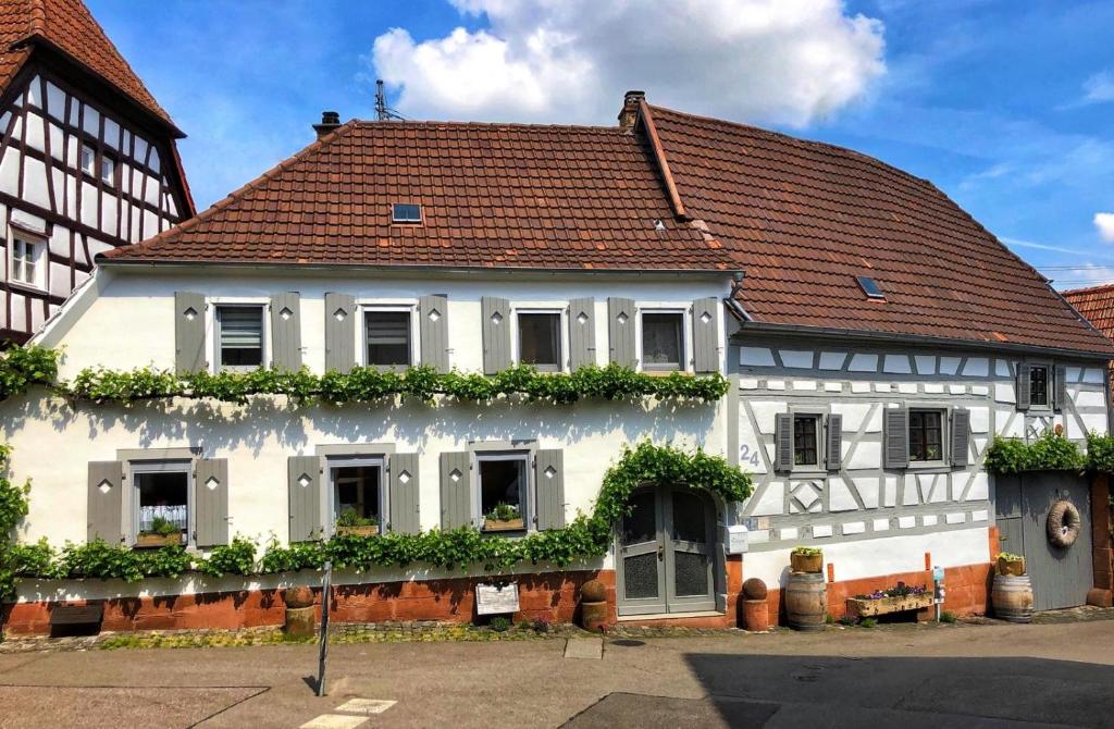 ein weißes Haus mit rotem Dach in der Unterkunft Ferienwohnung Sambachhaus in Gleiszellen-Gleishorbach