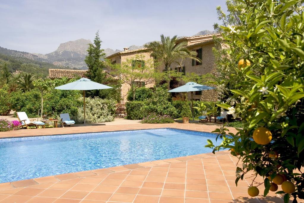 a swimming pool in front of a house at Finca Ca's Curial - Agroturismo - Adults Only in Sóller